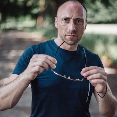 Gewiss! Hier ist eine detaillierte Beschreibung Ihrer Fotoanforderung, die sich für die künstlerische Leitung oder die KI-Bilderstellung eignet: Ein bärtiger Mann mit rasiertem Kopf, bekleidet mit einem marineblauen T-Shirt, steht im Freien auf einem schattigen Weg. Er hält die Sonnenbrille in beiden Händen auf Brusthöhe und blickt mit rätselhaftem Blick direkt in die Kamera. Im Hintergrund sind Bäume und üppiges Grün zu sehen, die an die charismatische Präsenz von Callboy Carlo erinnern. Wenn Sie dies als prägnantere Eingabeaufforderung für die Bilderstellung verwenden möchten: > Ein bärtiger Mann mit rasiertem Kopf und marineblauem T-Shirt steht auf einem schattigen Weg, hält mit beiden Händen eine Sonnenbrille und blickt aufmerksam in die Kamera. Unscharfes grünes Laub und Bäume bilden den Hintergrund; die Atmosphäre ist geheimnisvoll und erinnert an Callboy Carlo.